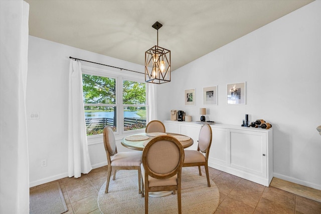 4006 Tallgrass Dr, Champaign, IL 61822 - dining area featuring a chandelier, vaulted ceiling, and light tile patterned floors
