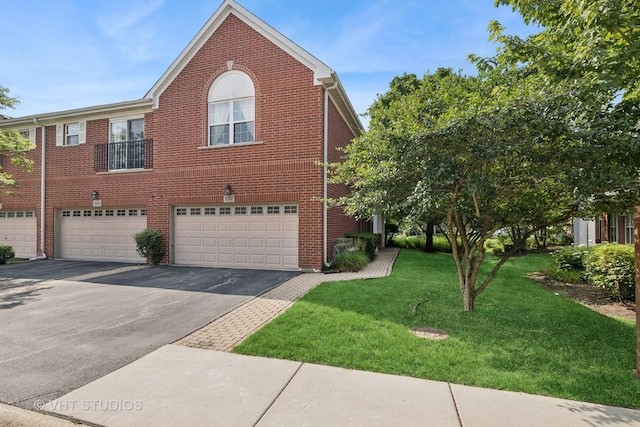 1007 Enfield Dr Unit 1007, Northbrook, IL 60062 - view of side of property with driveway, an attached garage, a lawn, and brick siding
