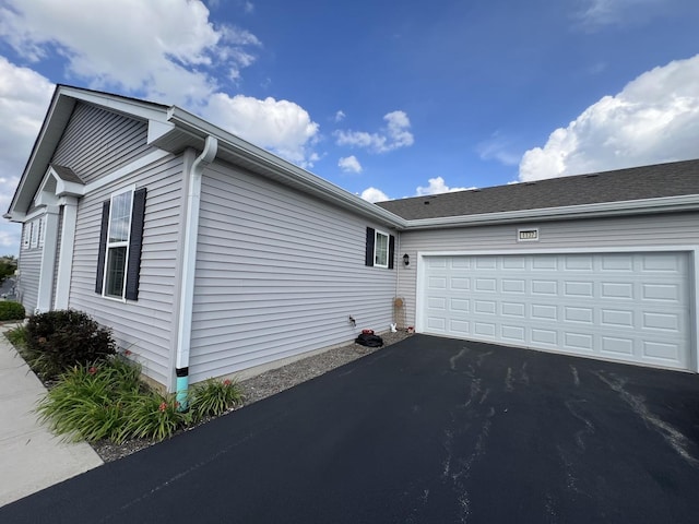 1137 Crestview Ln, Pingree Grove, IL 60140 - view of side of home with asphalt driveway and an attached garage