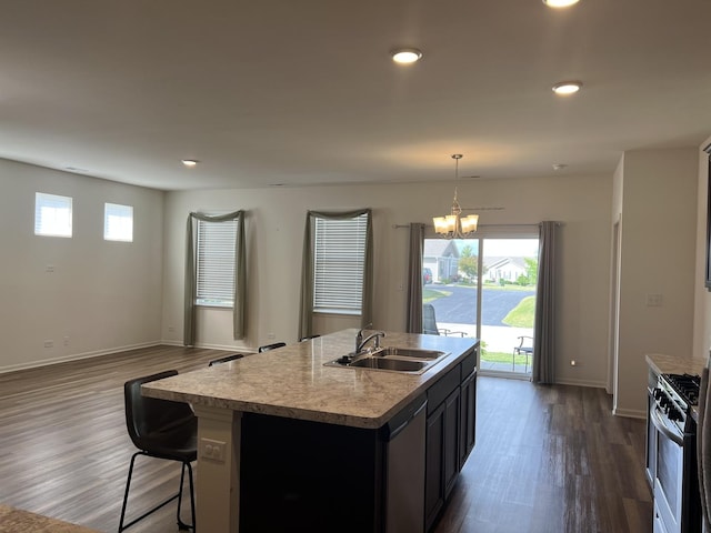 1137 Crestview Ln, Pingree Grove, IL 60140 - kitchen featuring stainless steel appliances, dark wood finished floors, a chandelier, a center island with sink, and light countertops