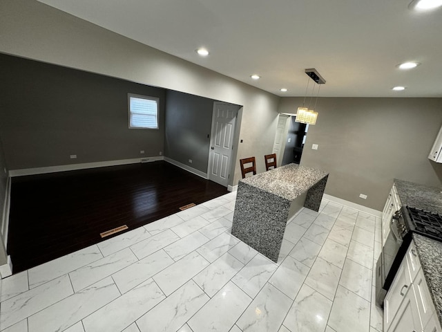 7772 Lawler Ave, Burbank, IL 60459 - kitchen featuring light marble finish floors, recessed lighting, white cabinetry, stone counters, and black range with gas stovetop