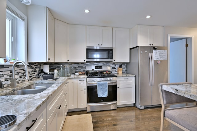 6869 N Overhill Ave Unit 2B, Chicago, IL 60631 - kitchen featuring stainless steel appliances, white cabinetry, decorative backsplash, light stone counters, and recessed lighting