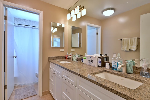6869 N Overhill Ave Unit 2B, Chicago, IL 60631 - bathroom featuring double vanity and a shower with shower curtain