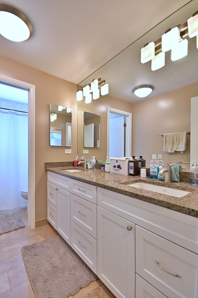 6869 N Overhill Ave Unit 2B, Chicago, IL 60631 - full bathroom featuring double vanity, tile patterned flooring, and curtained shower
