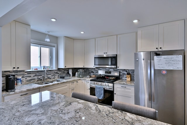 6869 N Overhill Ave Unit 2B, Chicago, IL 60631 - kitchen featuring stainless steel appliances, white cabinetry, backsplash, light stone countertops, and recessed lighting