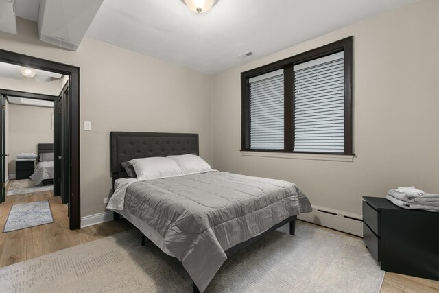 5901 N Navarre Ave, Chicago, IL 60631 - bedroom featuring baseboard heating and light wood finished floors