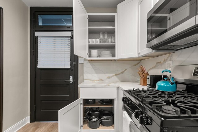 5901 N Navarre Ave, Chicago, IL 60631 - kitchen with appliances with stainless steel finishes, white cabinets, light countertops, light wood finished floors, and tasteful backsplash