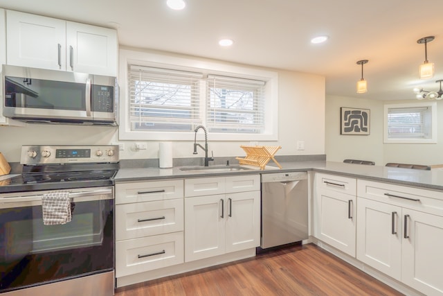 5901 N Navarre Ave, Chicago, IL 60631 - kitchen with stainless steel appliances, wood finished floors, white cabinetry, decorative light fixtures, and recessed lighting