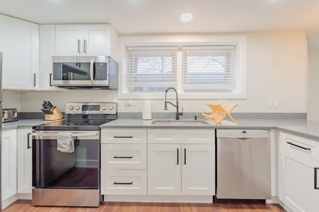 5901 N Navarre Ave, Chicago, IL 60631 - kitchen with stainless steel appliances, white cabinetry, light countertops, recessed lighting, and light wood-style flooring
