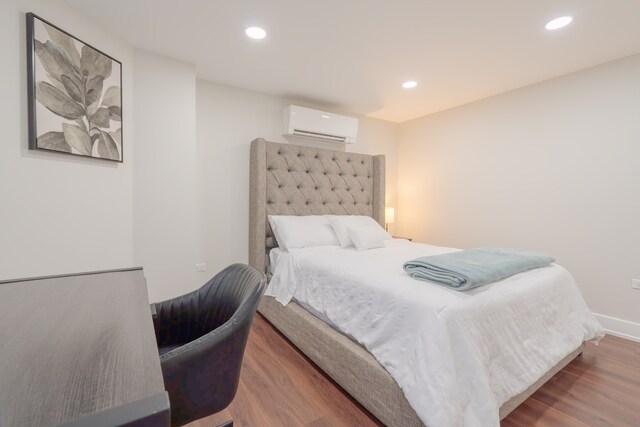 5901 N Navarre Ave, Chicago, IL 60631 - bedroom featuring an AC wall unit, wood finished floors, and recessed lighting