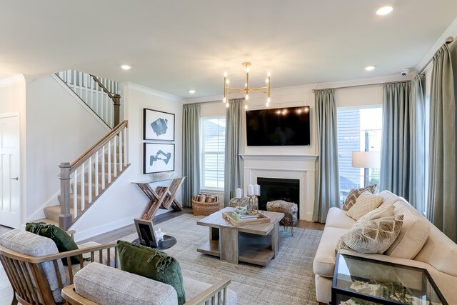 16642 S Sun Meadow Dr, Lockport, IL 60441 - living area with crown molding, stairway, a fireplace, recessed lighting, and a chandelier