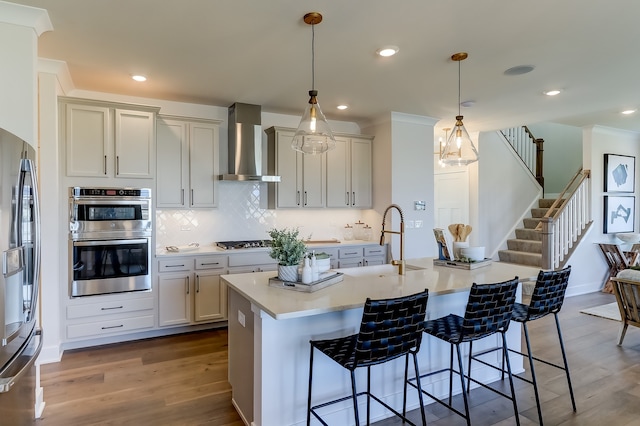 16642 S Sun Meadow Dr, Lockport, IL 60441 - kitchen with wall chimney range hood, appliances with stainless steel finishes, a kitchen breakfast bar, wood finished floors, and recessed lighting