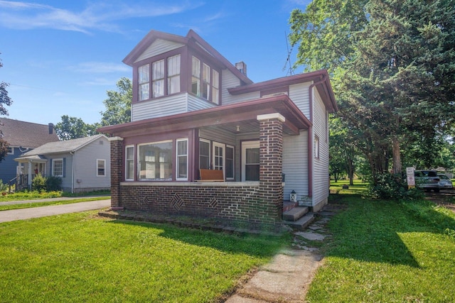 428 E Wilson St, Batavia, IL 60510 - view of front of home featuring a front lawn, a chimney, and brick siding