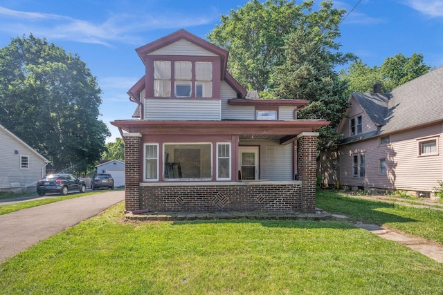 428 E Wilson St, Batavia, IL 60510 - view of front of house featuring brick siding, a front lawn, and a porch