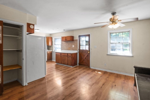 428 E Wilson St, Batavia, IL 60510 - kitchen with brown cabinets, ceiling fan, light wood finished floors, freestanding refrigerator, and tasteful backsplash