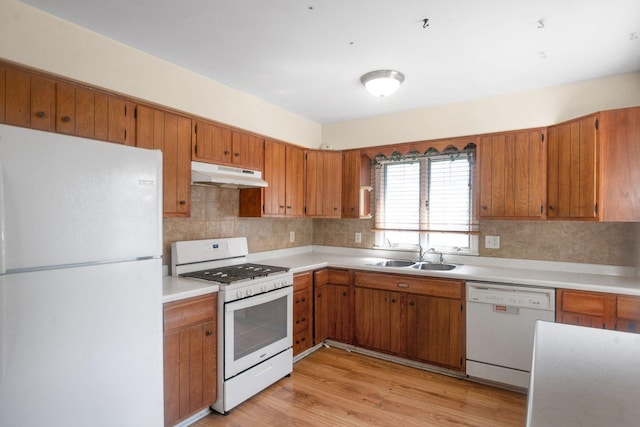 428 E Wilson St, Batavia, IL 60510 - kitchen with white appliances, under cabinet range hood, backsplash, brown cabinets, and light countertops