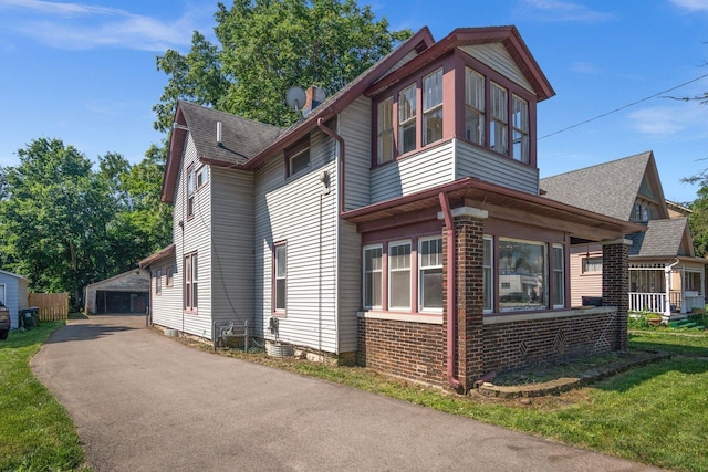 428 E Wilson St, Batavia, IL 60510 - view of front of property with an outbuilding, a garage, brick siding, and a shingled roof