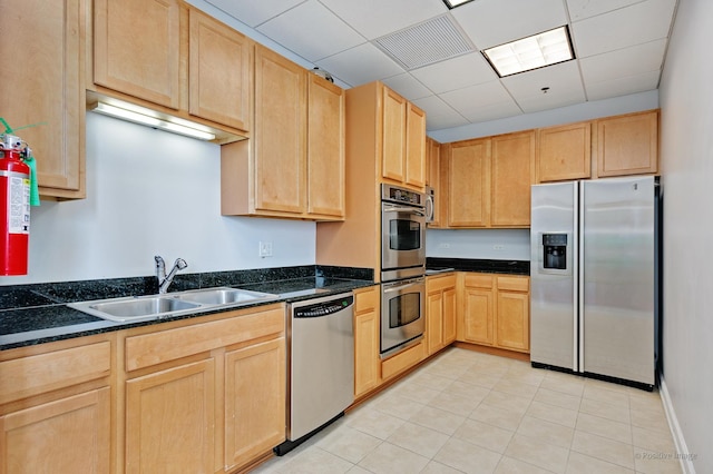 1841 S Calumet Ave Unit 1008, Chicago, IL 60616 - kitchen featuring appliances with stainless steel finishes, light brown cabinets, a paneled ceiling, dark stone counters, and light tile patterned floors