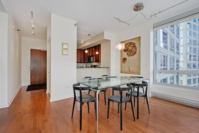 1841 S Calumet Ave Unit 1008, Chicago, IL 60616 - dining room with rail lighting, a baseboard radiator, and wood finished floors