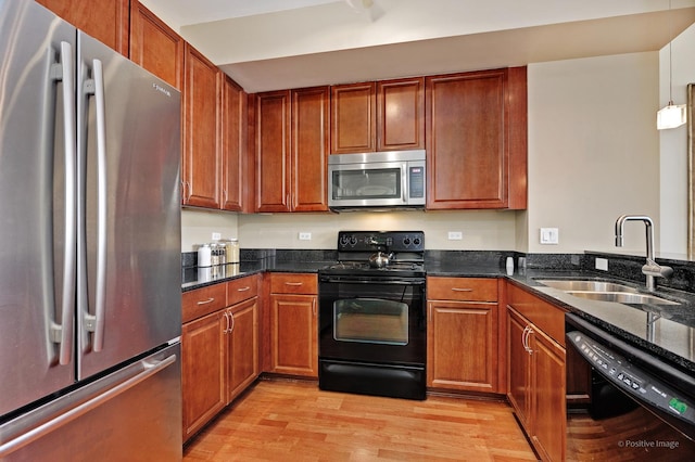1841 S Calumet Ave Unit 1008, Chicago, IL 60616 - kitchen with black appliances, light wood finished floors, dark stone countertops, and brown cabinetry