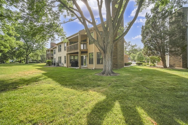 13 Willow Pkwy, Buffalo Grove, IL 60089 - rear view of property with a balcony, a chimney, and a yard