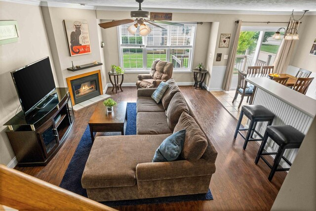 1201 Riviera Dr, Bloomington, IL 61701 - living area with healthy amount of natural light, wood finished floors, a fireplace with flush hearth, and crown molding