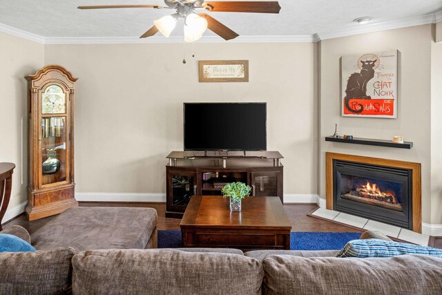 1201 Riviera Dr, Bloomington, IL 61701 - living area featuring a fireplace with flush hearth, crown molding, a ceiling fan, and wood finished floors