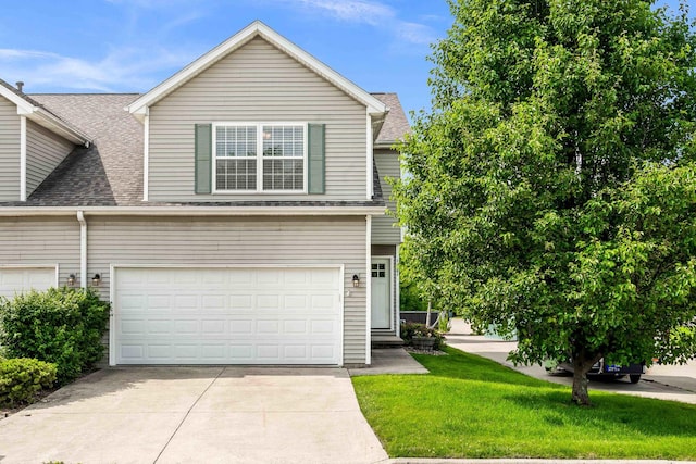 1201 Riviera Dr, Bloomington, IL 61701 - view of front facade featuring roof with shingles, driveway, an attached garage, and a front yard
