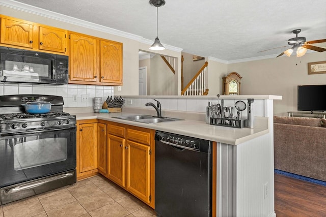 1201 Riviera Dr, Bloomington, IL 61701 - kitchen with black appliances, a peninsula, open floor plan, light countertops, and a ceiling fan