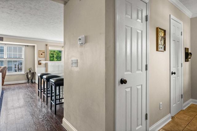 1201 Riviera Dr, Bloomington, IL 61701 - hallway featuring crown molding, a textured ceiling, and wood finished floors