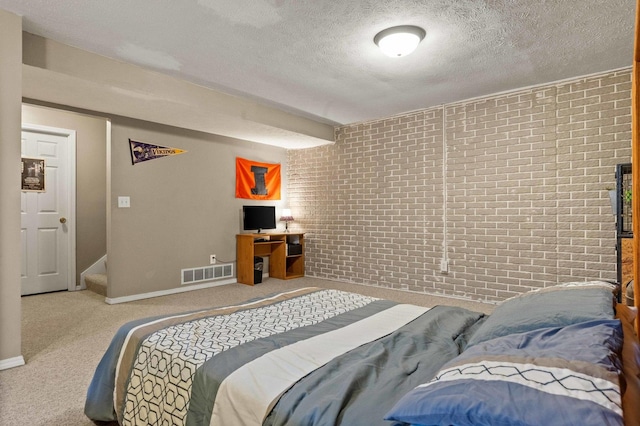 1201 Riviera Dr, Bloomington, IL 61701 - bedroom with brick wall, carpet flooring, and a textured ceiling