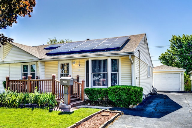 4209 SW Hwy Unit 4209, Hometown, IL 60456 - view of front of home with roof with shingles, driveway, an outbuilding, and roof mounted solar panels