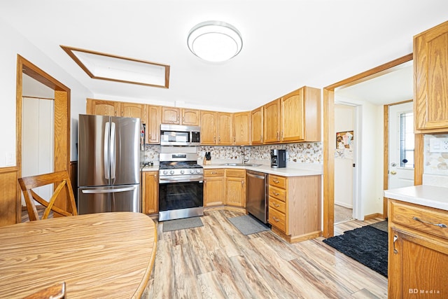 4209 SW Hwy Unit 4209, Hometown, IL 60456 - kitchen featuring appliances with stainless steel finishes, light wood finished floors, light countertops, and backsplash