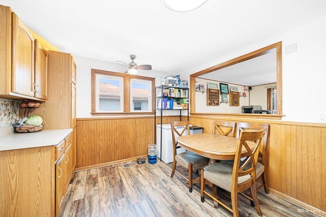 4209 SW Hwy Unit 4209, Hometown, IL 60456 - dining space featuring wainscoting, light wood-type flooring, ceiling fan, and wood walls