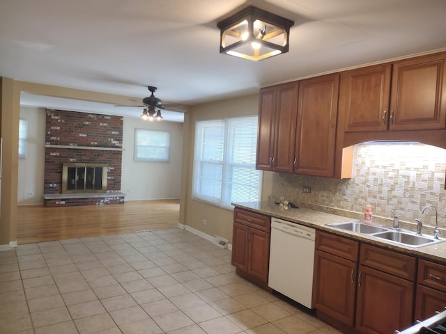 1544 Towhee Ln, Naperville, IL 60565 - kitchen featuring white dishwasher, ceiling fan, brown cabinetry, light tile patterned flooring, and backsplash