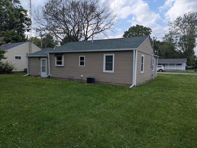 707 E Van Allen St, Tuscola, IL 61953 - back of property with a lawn and a shingled roof