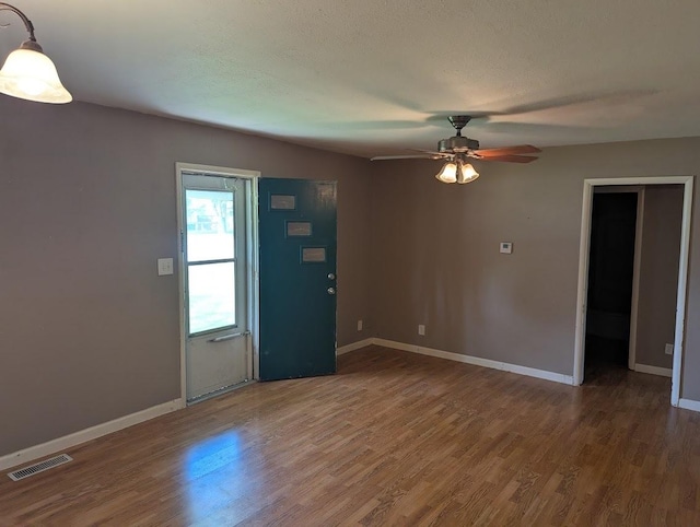 707 E Van Allen St, Tuscola, IL 61953 - unfurnished room with wood finished floors and a ceiling fan