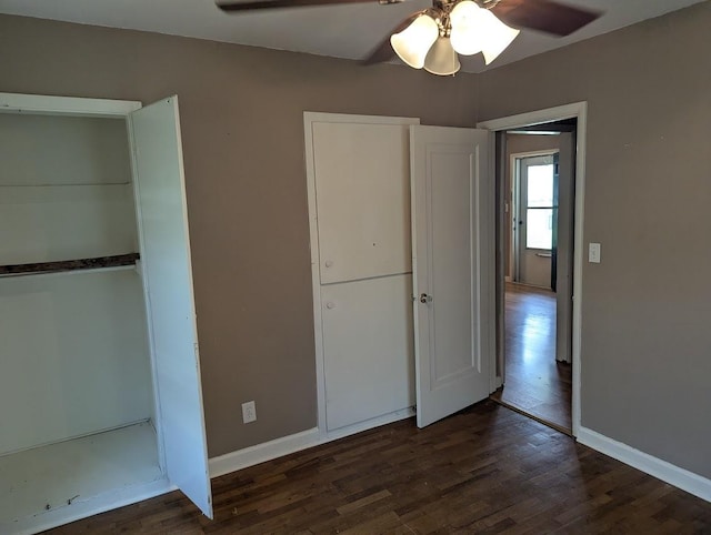 707 E Van Allen St, Tuscola, IL 61953 - unfurnished bedroom featuring dark wood-style floors and a ceiling fan
