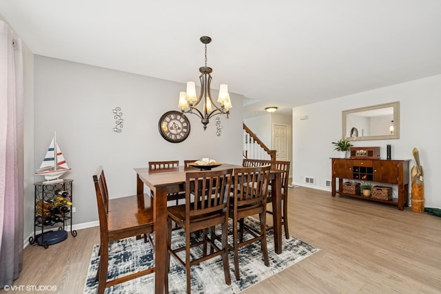 2714 Arbor Dr, Mchenry, IL 60050 - dining area featuring light wood-type flooring and a chandelier