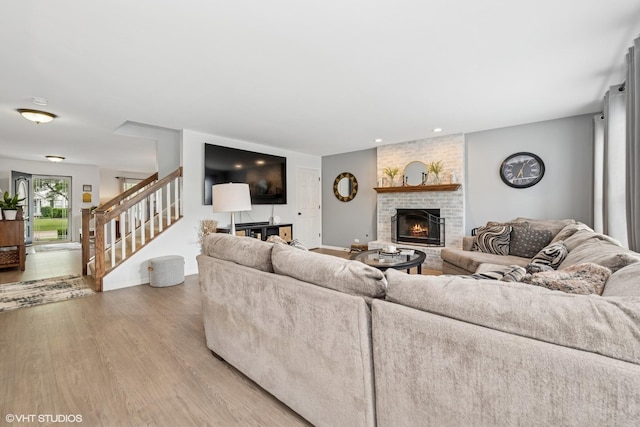 2714 Arbor Dr, Mchenry, IL 60050 - living room featuring a fireplace, light wood-style flooring, stairway, and recessed lighting