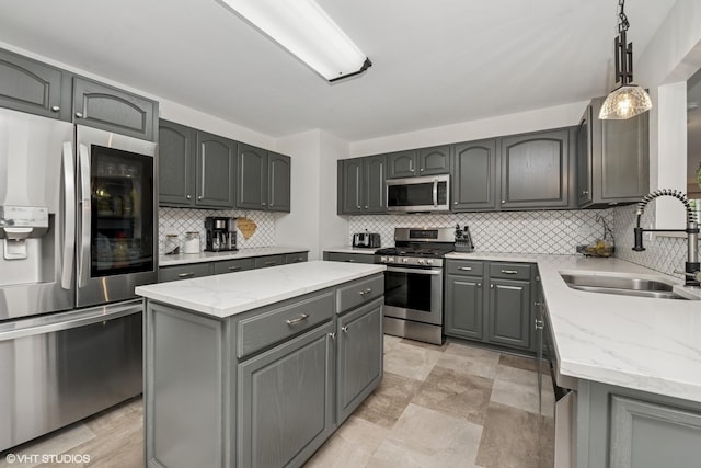 2714 Arbor Dr, Mchenry, IL 60050 - kitchen featuring appliances with stainless steel finishes, a center island, gray cabinets, and decorative backsplash