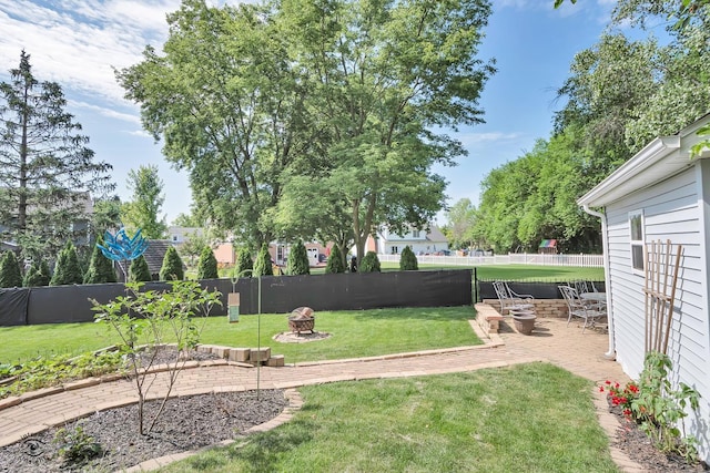 235 Fox Trail Ct, Bourbonnais, IL 60914 - fenced backyard with a fire pit and a patio area