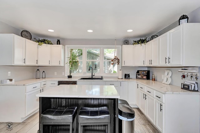 235 Fox Trail Ct, Bourbonnais, IL 60914 - kitchen featuring light stone counters, white cabinetry, light wood finished floors, a kitchen bar, and recessed lighting