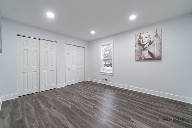 38236 N Lee Ave, Spring Grove, IL 60081 - unfurnished bedroom featuring multiple closets, dark wood finished floors, and recessed lighting