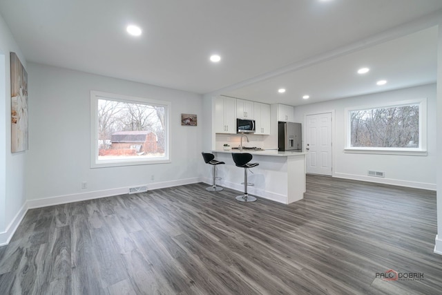 38236 N Lee Ave, Spring Grove, IL 60081 - kitchen featuring appliances with stainless steel finishes, white cabinets, dark wood-style floors, open floor plan, and recessed lighting