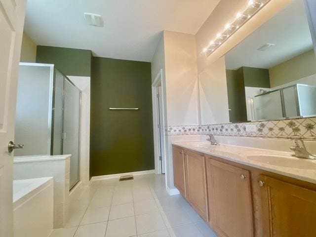 826 Bohannon Cir, Oswego, IL 60543 - full bathroom with a stall shower, tile patterned floors, double vanity, a garden tub, and tasteful backsplash