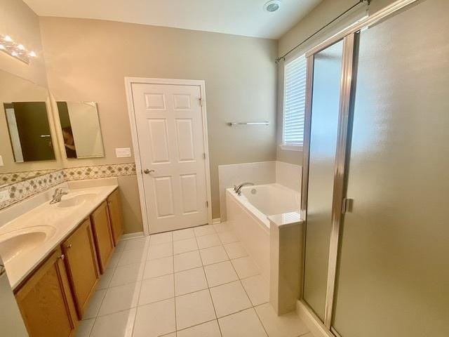 826 Bohannon Cir, Oswego, IL 60543 - bathroom with tile patterned flooring, double vanity, a garden tub, and a stall shower