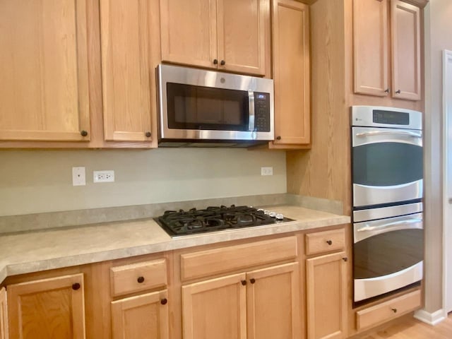 826 Bohannon Cir, Oswego, IL 60543 - kitchen featuring stainless steel appliances, light brown cabinetry, and light countertops