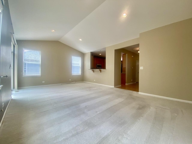 826 Bohannon Cir, Oswego, IL 60543 - unfurnished living room featuring lofted ceiling, light carpet, and recessed lighting