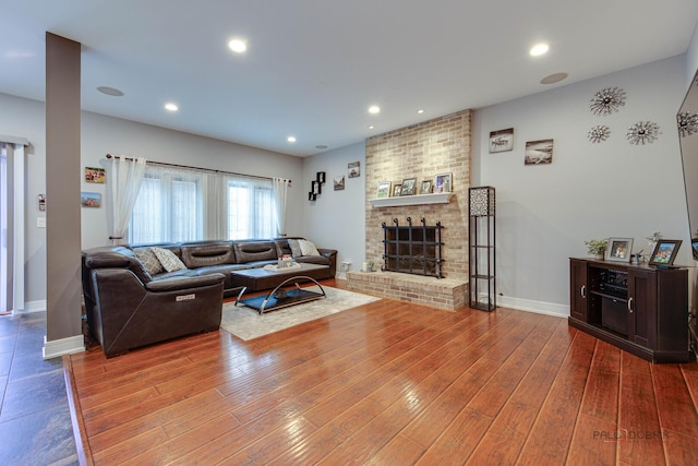 202 Dallas Dr, Bartlett, IL 60103 - living room with wood finished floors, a brick fireplace, and recessed lighting